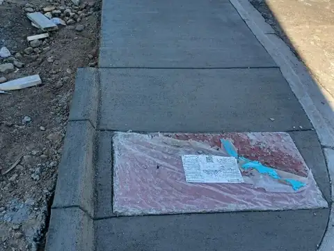 New concrete sidewalk and curb poured along a street corner